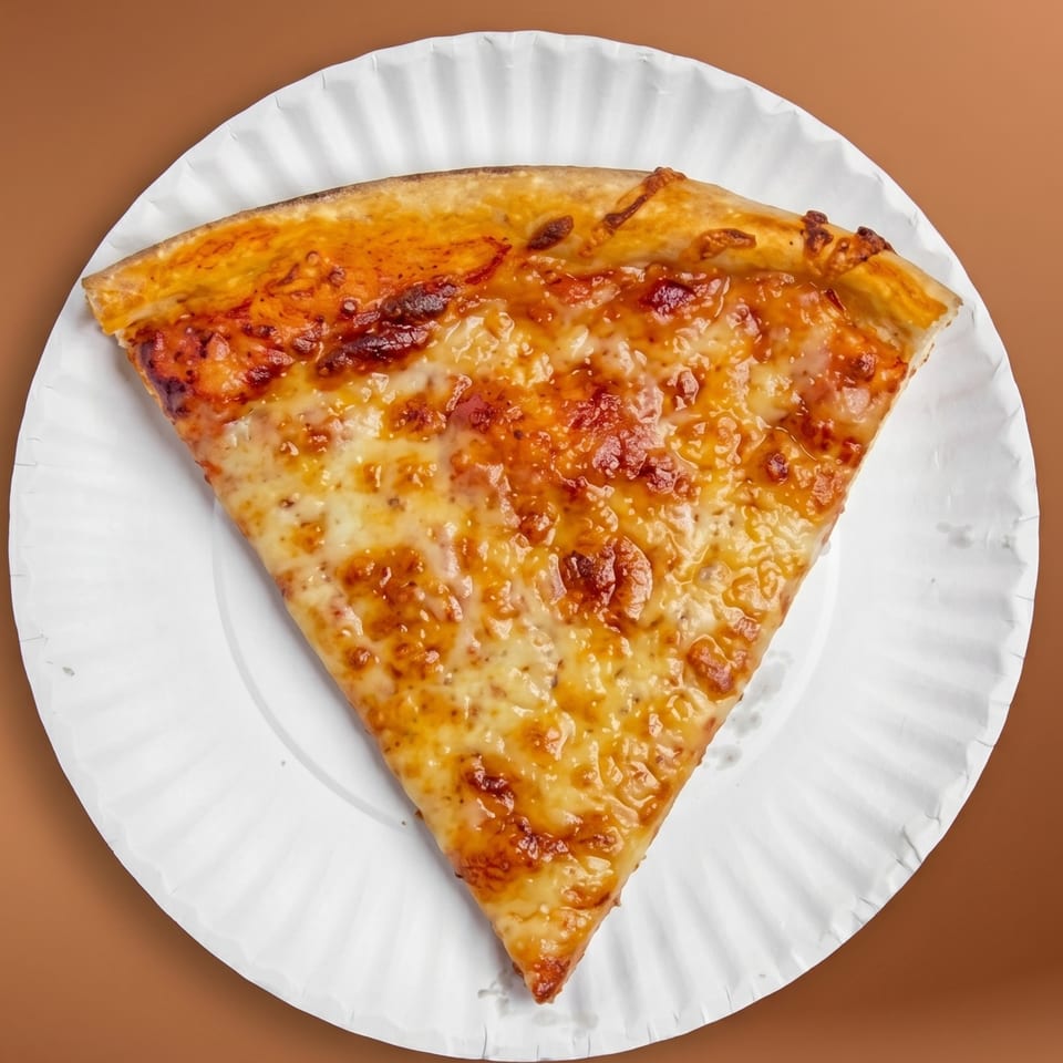 A single slice of cheese pizza with a golden crust on a white paper plate.